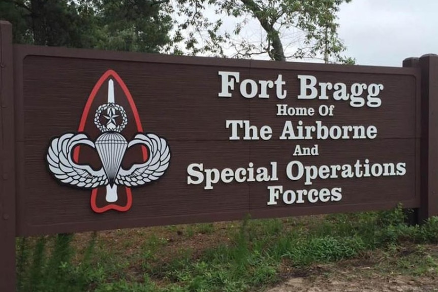 A brown sign reads "Fort Bragg, home of the airborne and special operations forces"