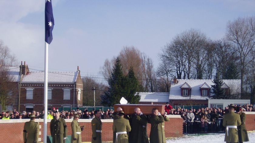 The coffin of an Australian soldier killed in Fromelles is carried to its resting place.