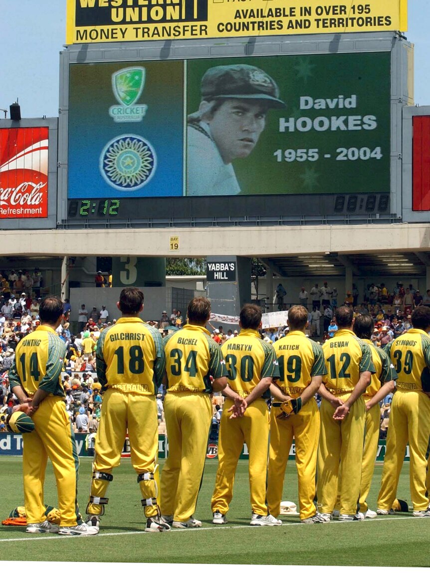 The Australian cricket team watches a video memorial to former Test cricketer David Hookes in 2004.