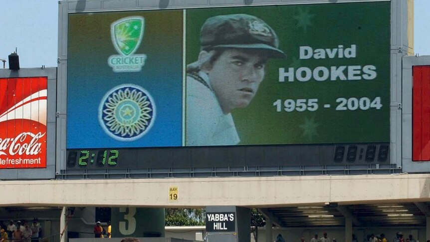 The Australian cricket team watches a video memorial to former Test cricketer David Hookes in 2004.