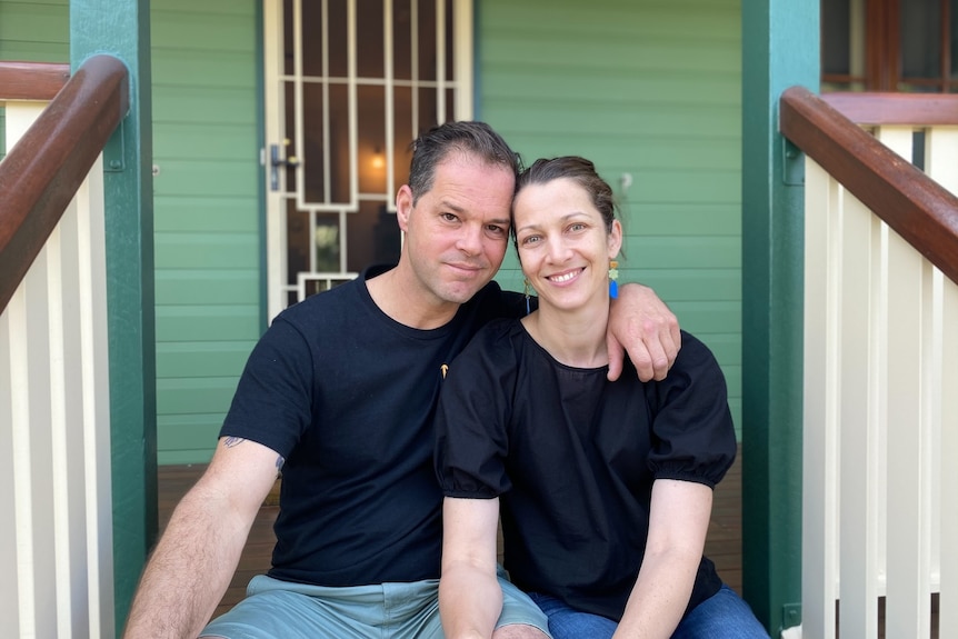 Amy and ross outside their home.