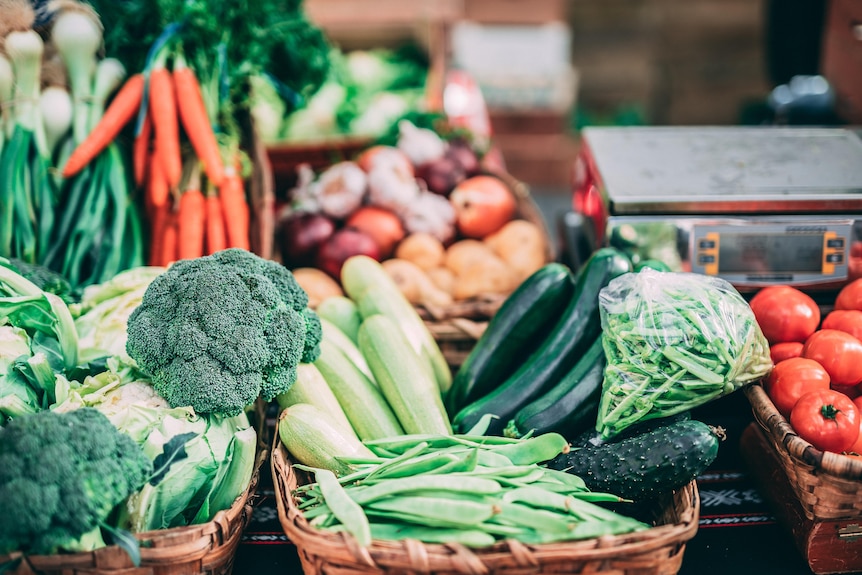 A pile of assorted vegetables on a bench.