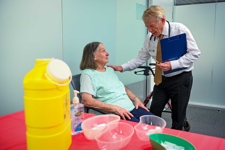 An elderly woman talking to her GP