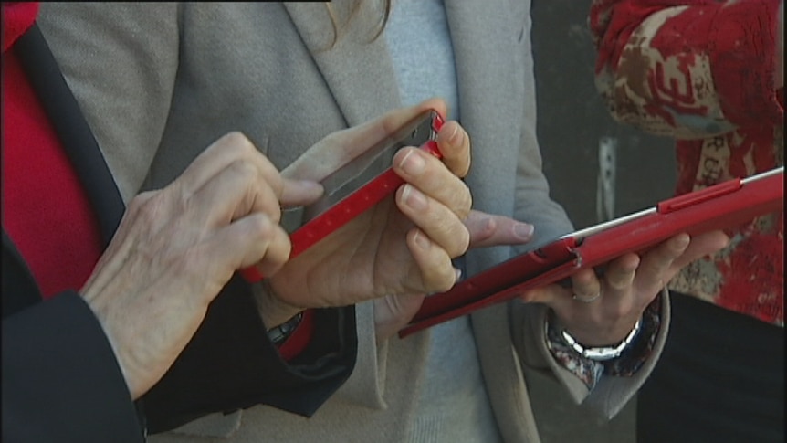Close up of hands using mobile devices