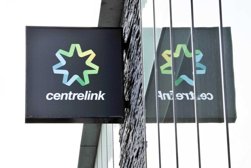 Centrelink sign on the wall of a building.