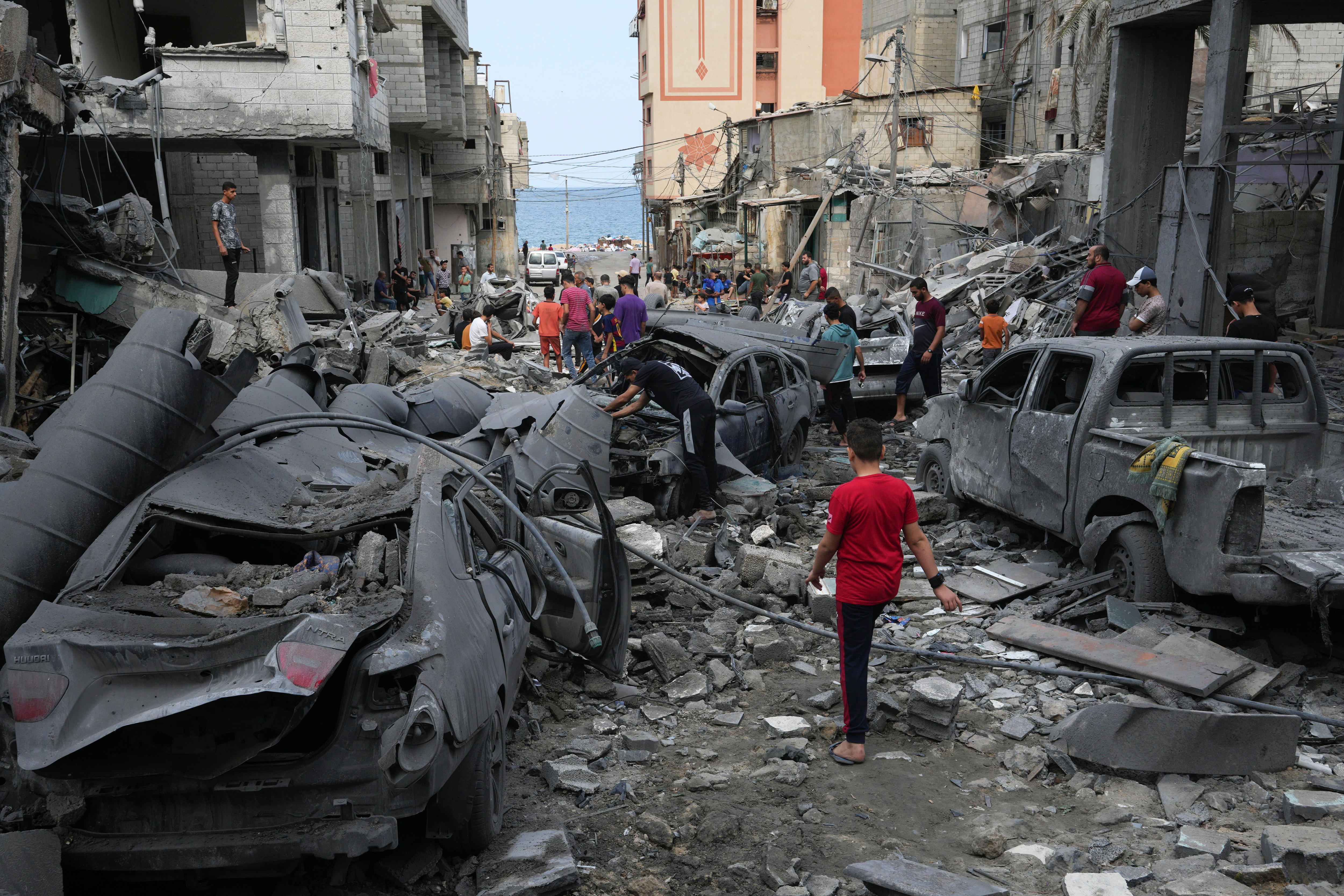 Palestinians inspect the rubble of the West mosque destroyed after it was hit by an Israeli airstrike.