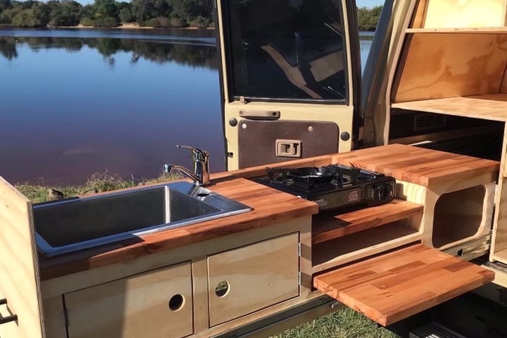 Rear van door open showing cook top on sliding draw.