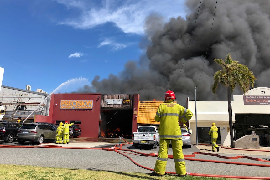 Firefighters battle a blaze at Precision Automatic Transmissions in the Perth suburb of Osborne Park.