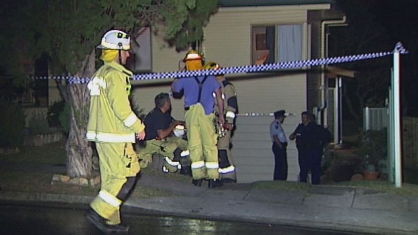Police and firefighters at the scene of a fatal fire at Mt Gravatt in Brisbane.