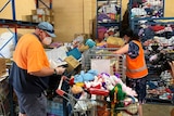 Volunteers wearing face masks sort donated items at St Vincent de Paul Central Queensland.