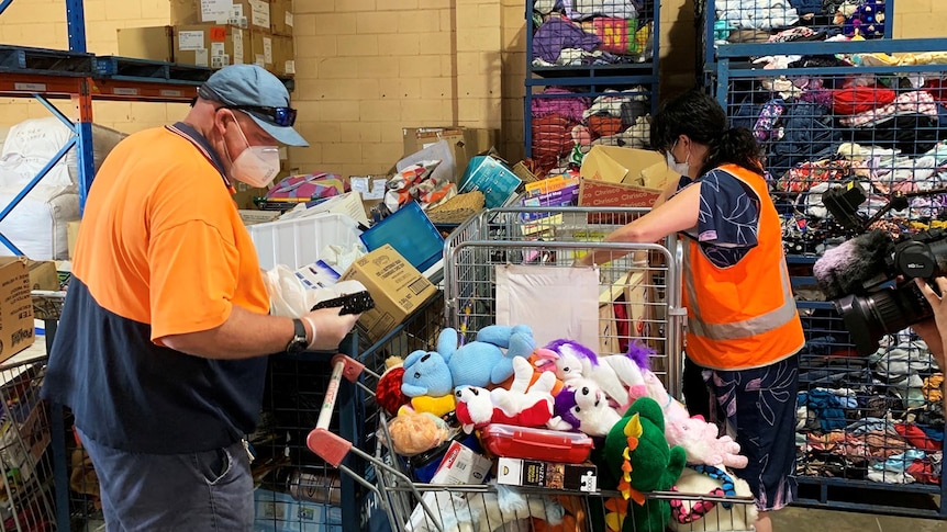 Volunteers wearing face masks sort donated items at St Vincent de Paul Central Queensland.