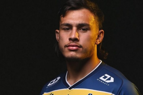 Male rugby league player posing for photograph in jersey.