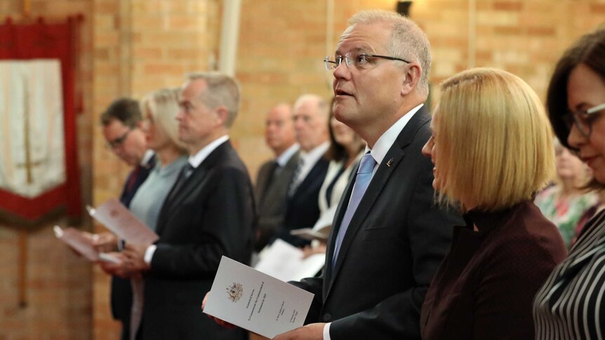PM Scott Morrison looks towards the heavens at a church service in Canberra