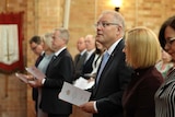 PM Scott Morrison looks towards the heavens at a church service in Canberra