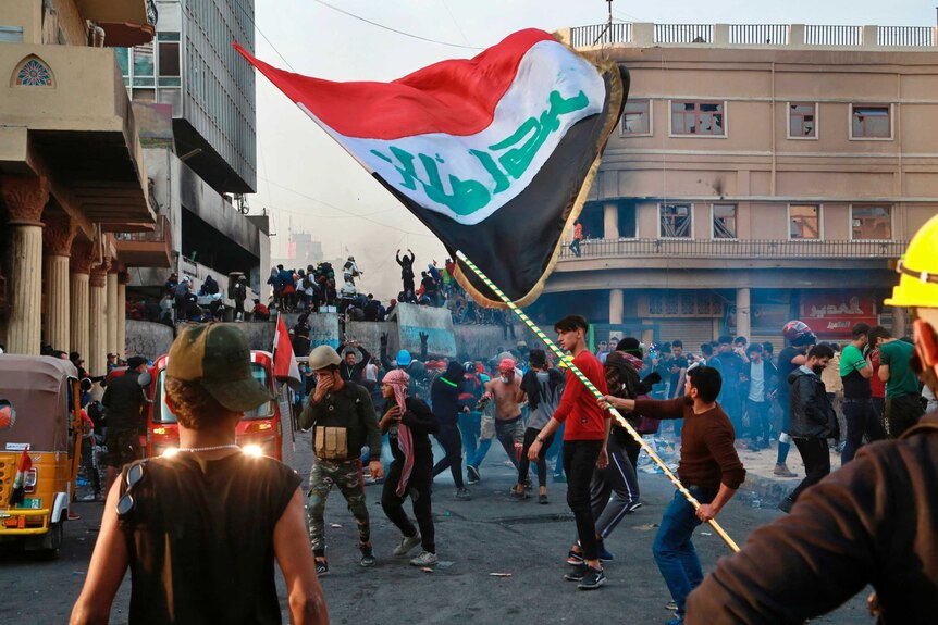 Anti-government protesters gather on Rasheed Street during clashes with security forces in Baghdad.