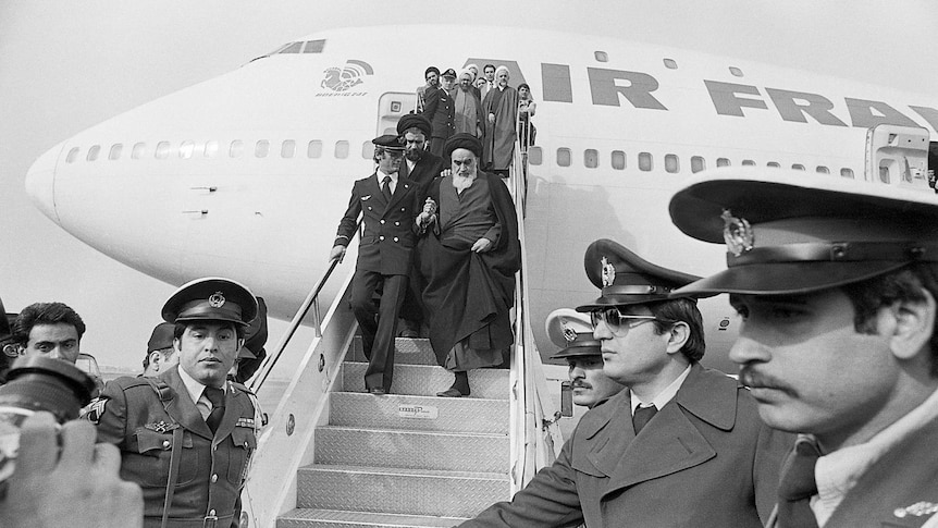 Ayatollah Khomeini, Iran's main opposition leader returns to Iran after 15 years of exile.