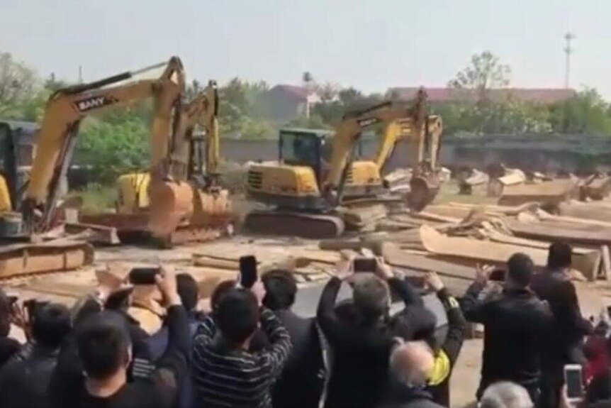 Excavators smash coffins in Jiangxi province, China