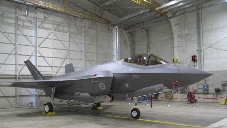 A fighter jet in a hangar