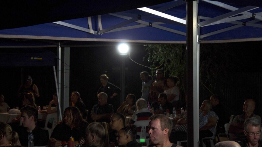 A crowd of people sit around tables at a function in Menzies, Western Australia.