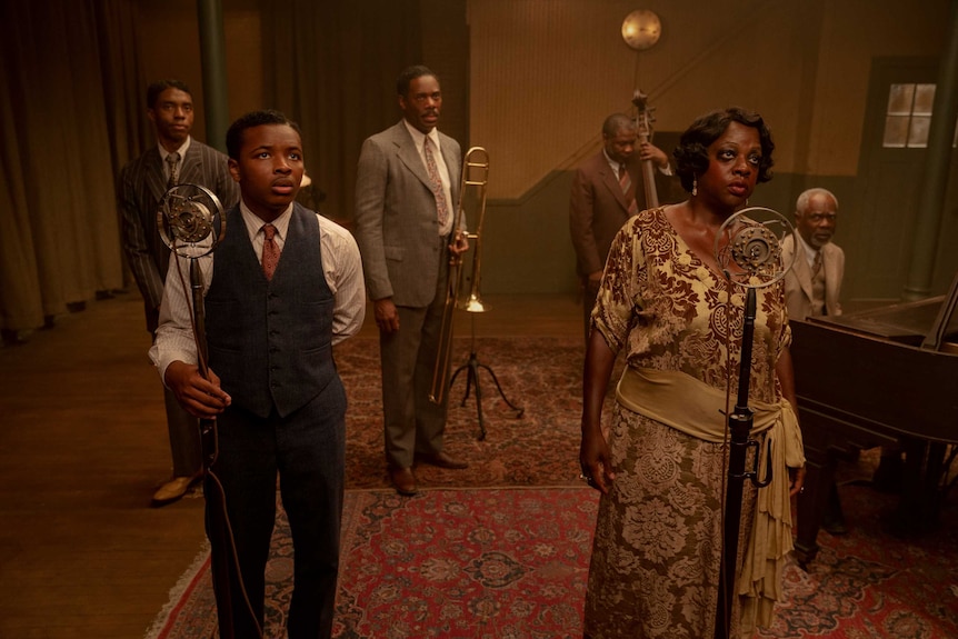 A scene from Ma Rainey's Black Bottom with a group of actors including Chadwick Boseman and Viola Davis as a blues band