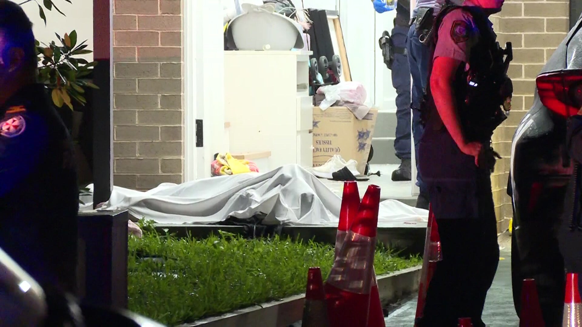 a body bag outside a house