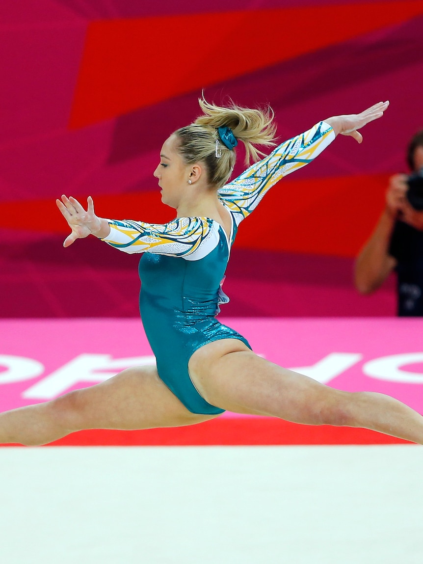 Gymnast Emily Little mid-air during a floor exercise. 