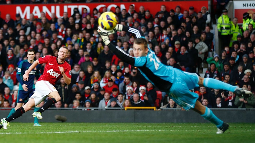 Superb one-two ... Manchester United's Tom Cleverley (L) guides the ball past Sunderland's Simon Mignolet.