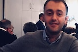 Young Turkish man smiles at the camera