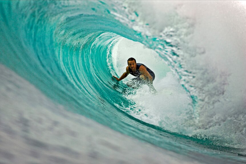 Surf writer Tim Baker catches a barrel