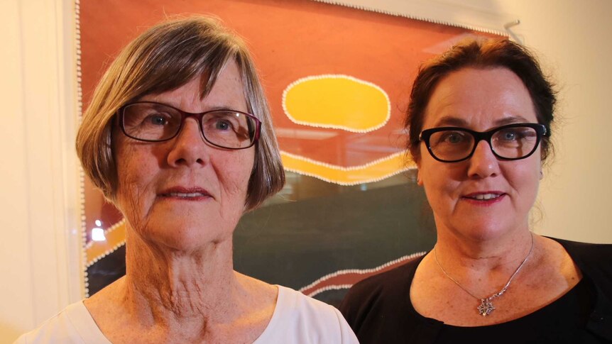 Professor Carol Bower and Dr Raewyn Mutch standing side by side with artwork in the background.