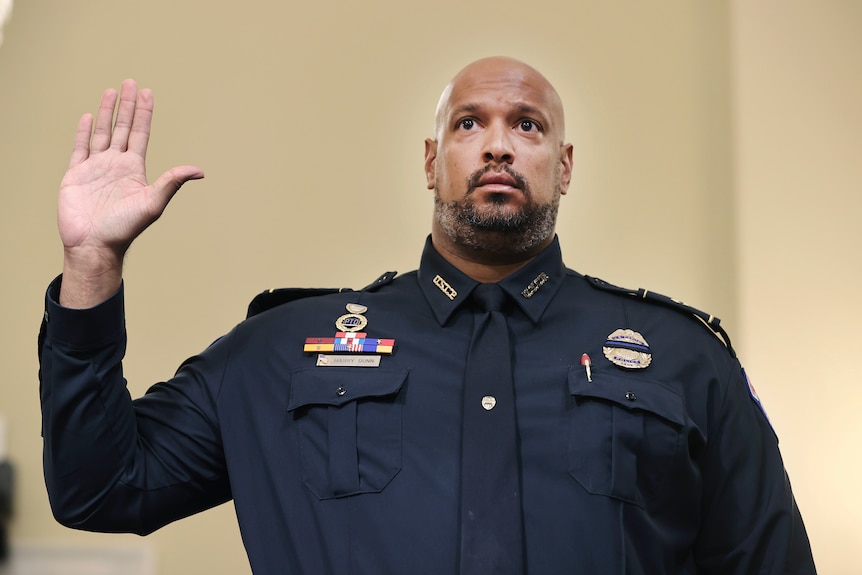 US Capitol Police Sergeant Harry Dunn raises his right hand and swears in before giving his testimony