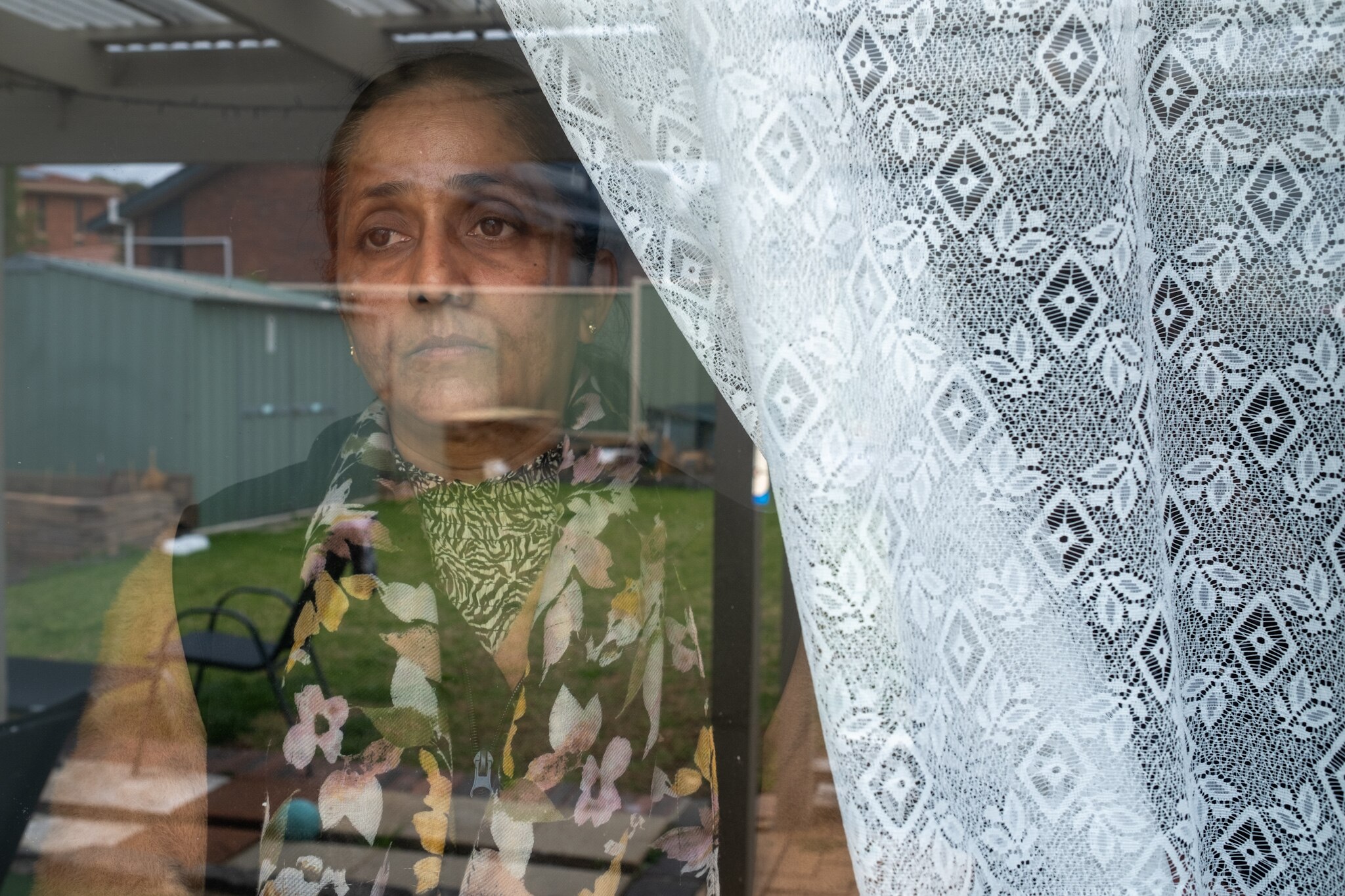 Sukhdeep Kaur looks out of a window.