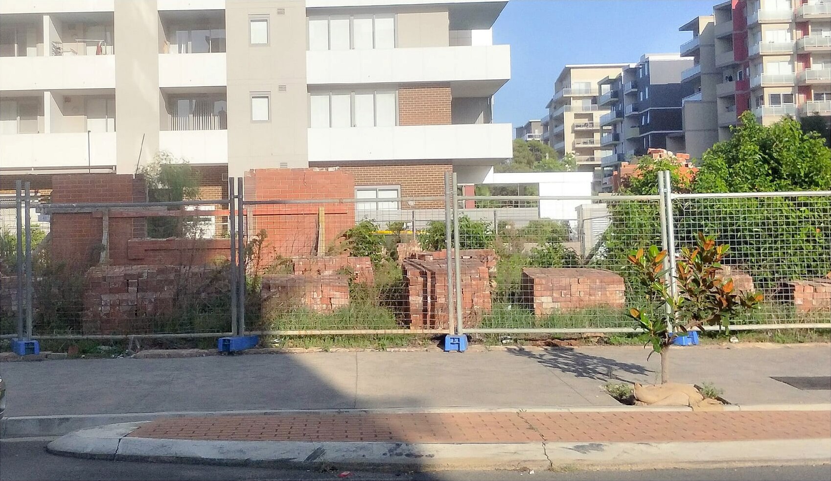 The remains of the heritage site in front of a new apartment building.