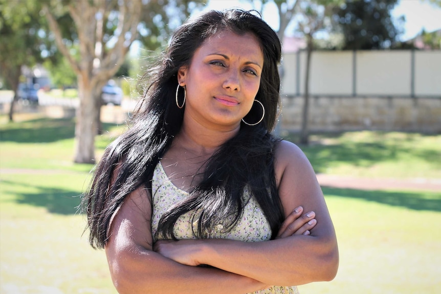 Woman standing in perth, with arms crossed