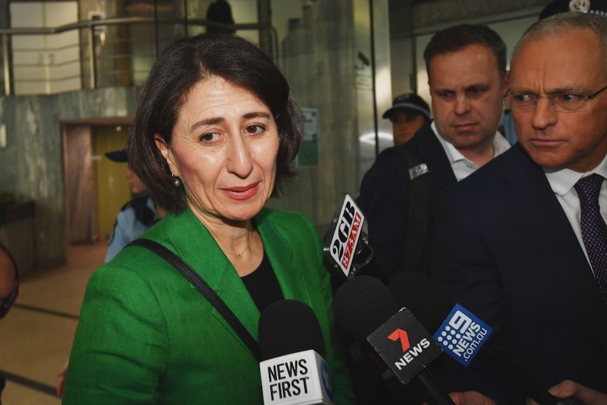 Gladys Berejiklian surrounded by media