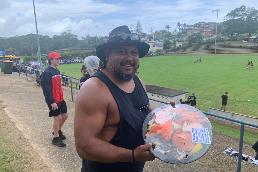 Troy Robinson shows off the seafood platter he won 