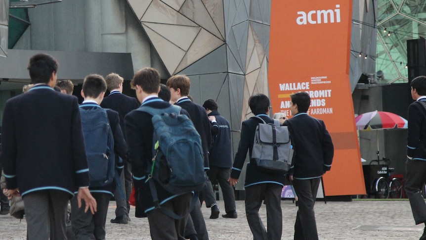 A group of students walk towards the box office entrance of the Australian Centre for the Moving Image.