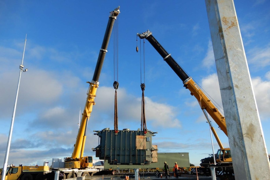 A wind turbine transformer being loaded onto a truck in Burnie, set for Granville Harbour wind farm, June 2019