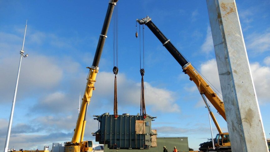 A wind turbine transformer being loaded onto a truck in Burnie, set for Granville Harbour wind farm, June 2019