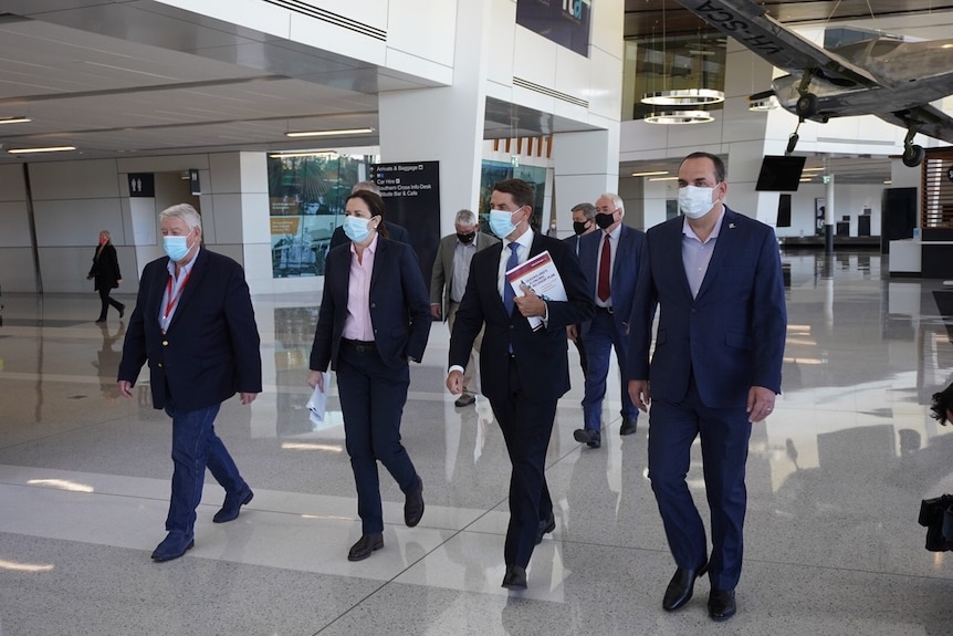 Premier Annastacia Palaszczuk, Treasurer Cameron Dick and businessman John Wagner walk together.