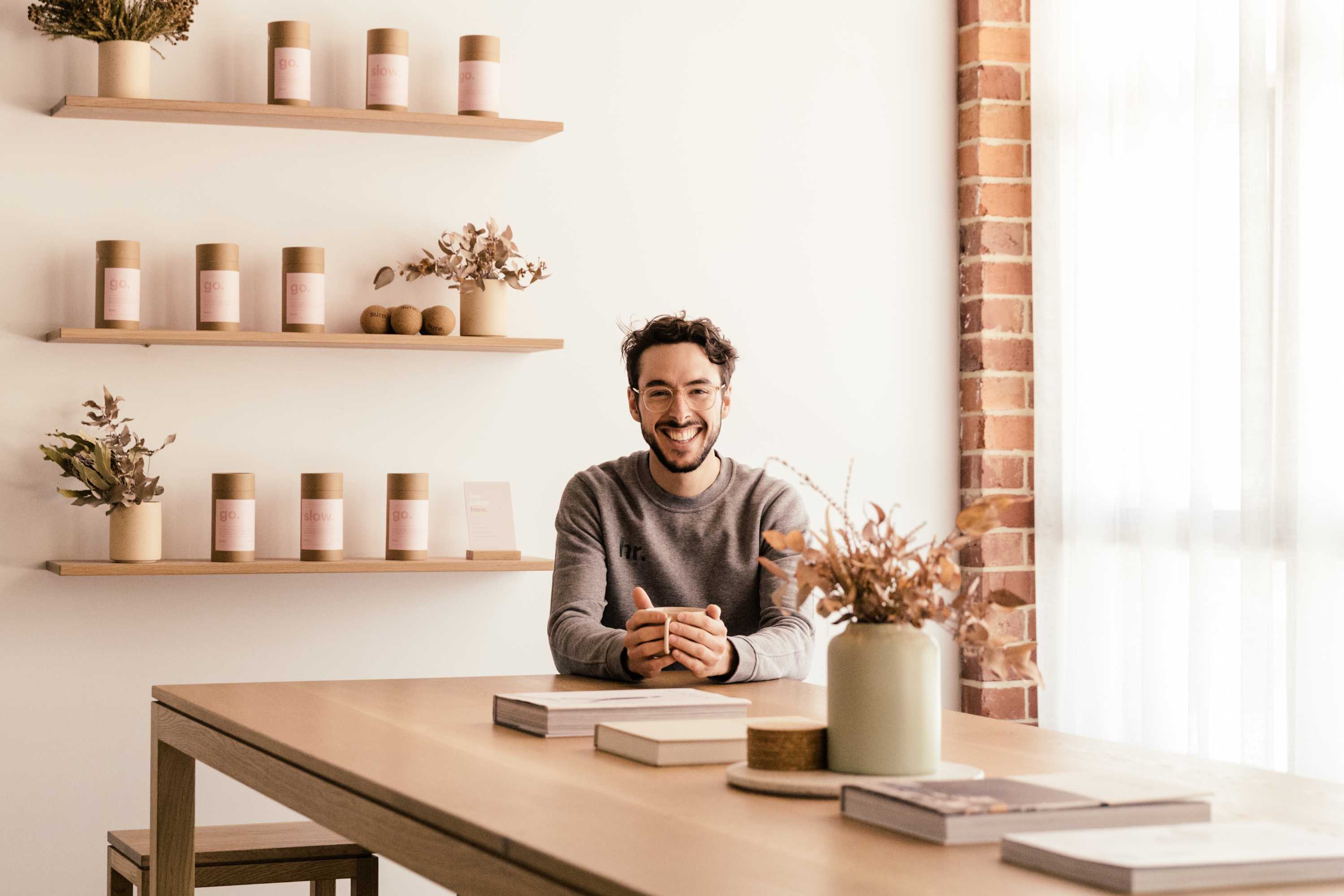 Charlie Murray sitting at a table in his yoga studio