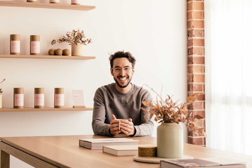 Charlie Murray sitting at a table in his yoga studio