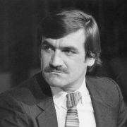 Black and white shot Barrie Cassidy looking off camera.