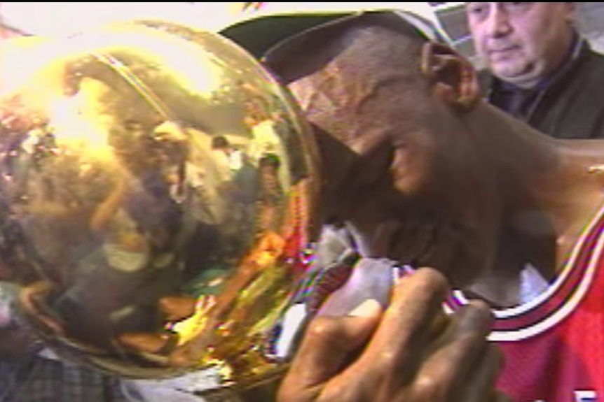 Michael Jordan cries while he hugs the Larry O'Brien Trophy after winning the 1991 NBA Finals.