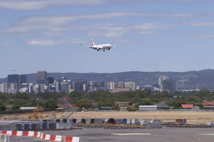 A Virgin Australia aeroplane lands at Adelaide Airport