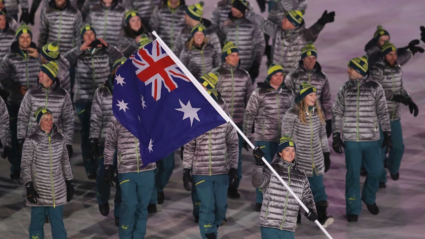 Australian team marches behind flag bearer Scotty James