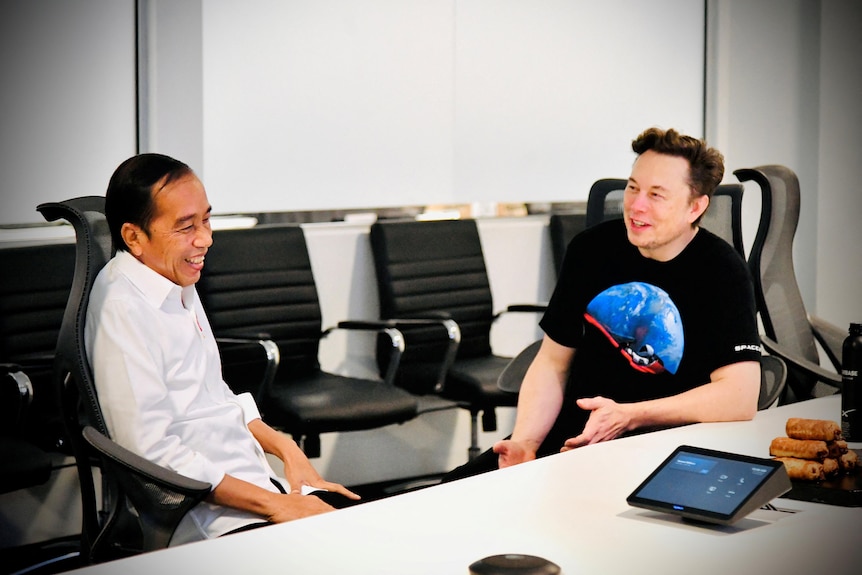 Indonesian President Joko Widodo laughs while talking with Elon Musk