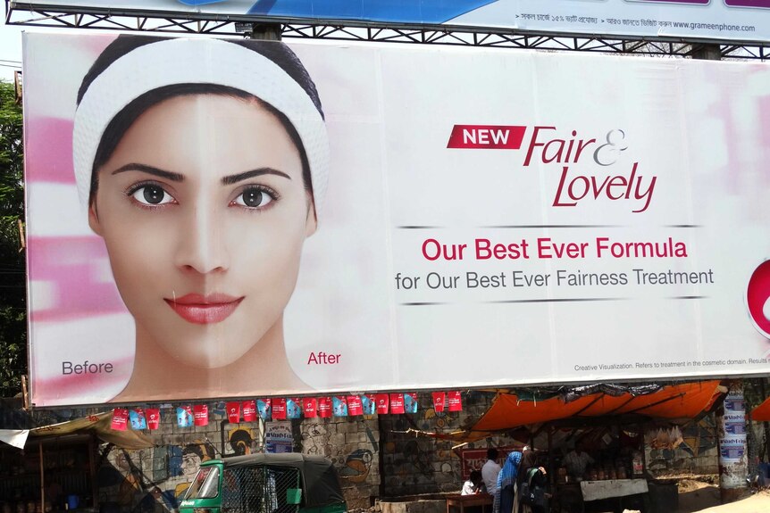 A bilboard selling a product called Fair and Lovely with a before and after photo of a woman.