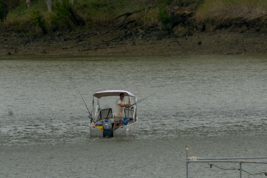 A man fishes from a small boat in Rockhampton, November 2021
