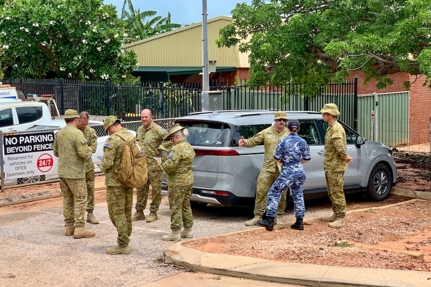 ADF members in military fatigues stand together talking, Broome, January 2023.